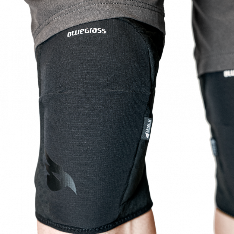 Bluegrass Arto knee pads worn on trail rider showing fit and coverage for enduro and eMTB riding